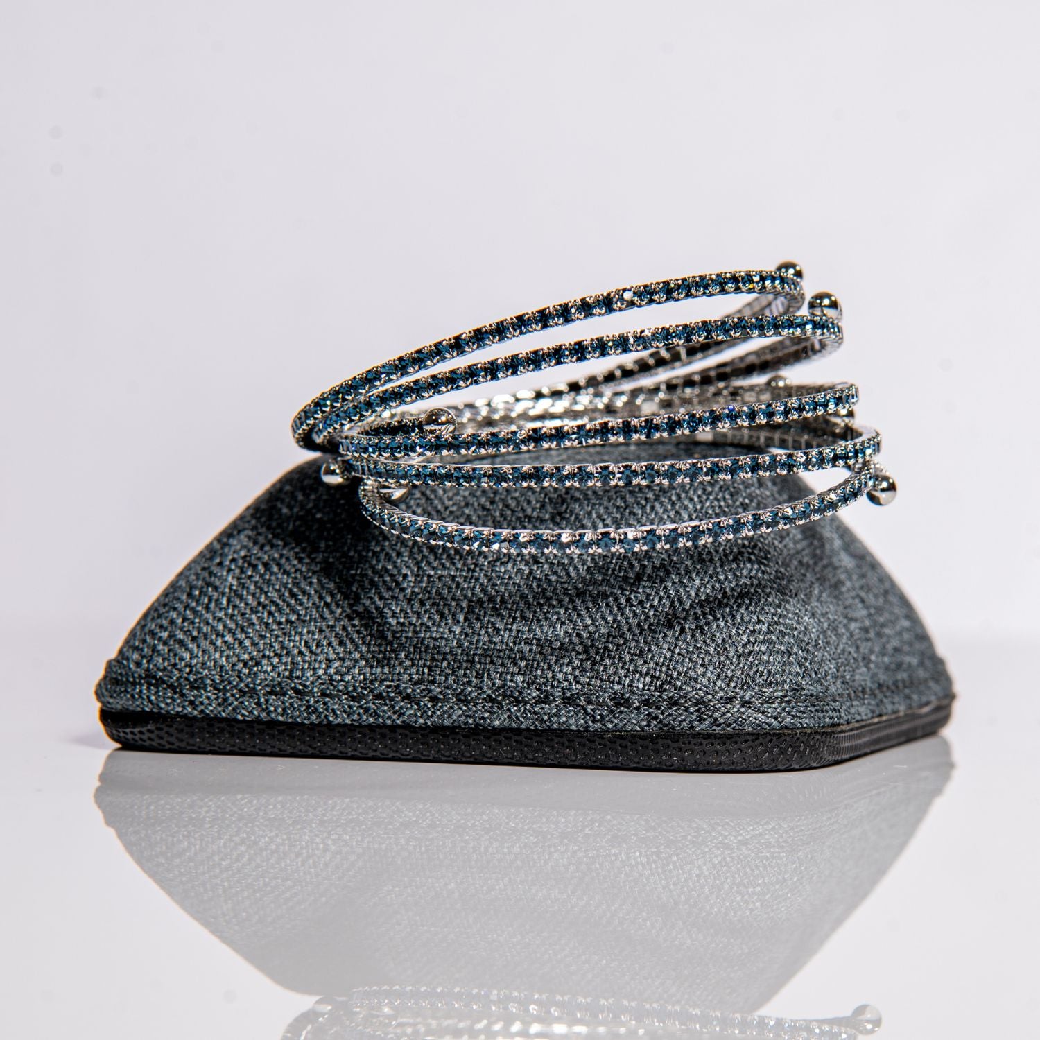September sapphire birthstone bangles in silver with royal blue crystals stacked showing flexible design