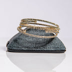 April diamond birthstone bangles in gold with clear crystals stacked to show one-size-fits-most design