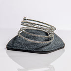 April diamond birthstone bangles in silver with clear crystals stacked showing flexible memory wire design
