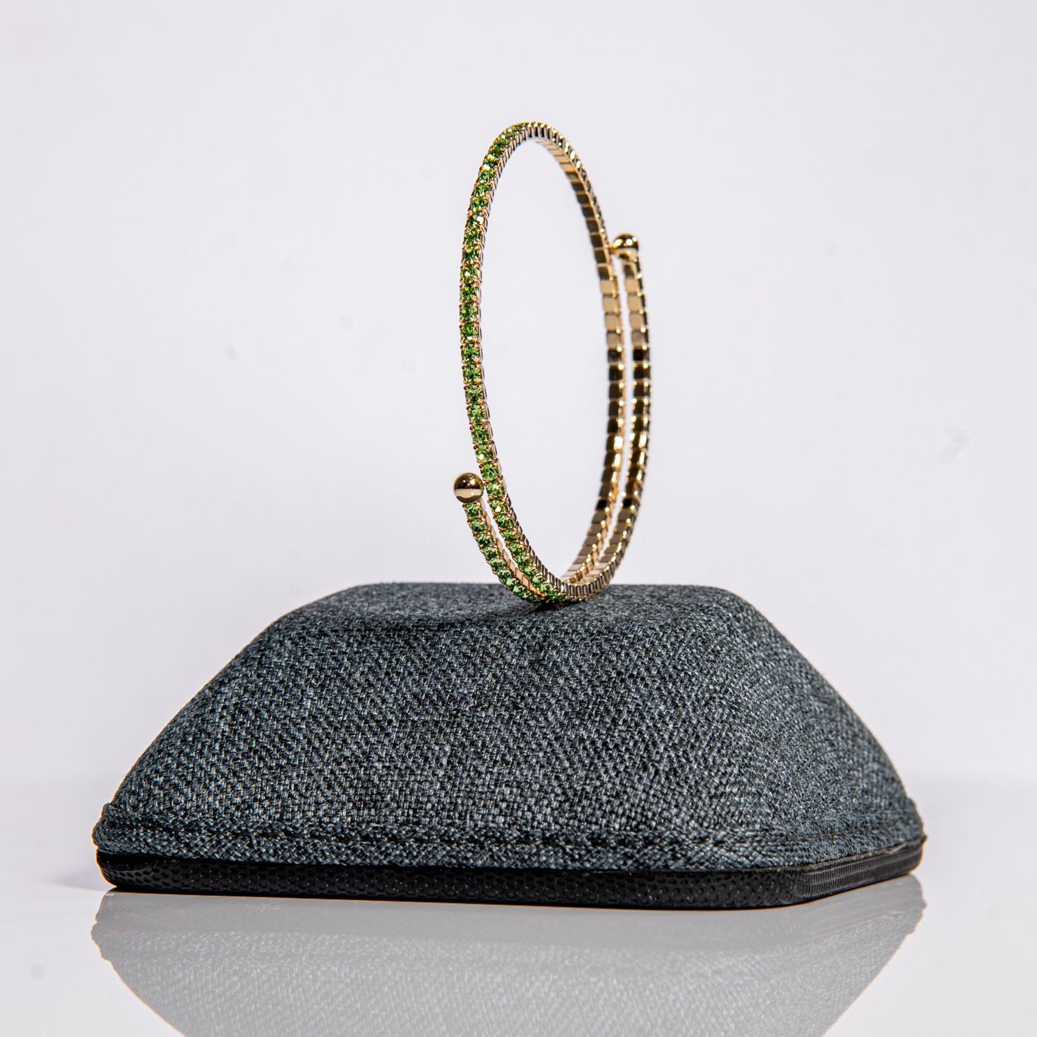 August peridot birthstone bangle in gold showing green crystals on one-size-fits-most design