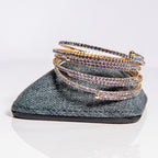 February amethyst birthstone bangles in gold stacked to demonstrate flexible fit and premium crystal design