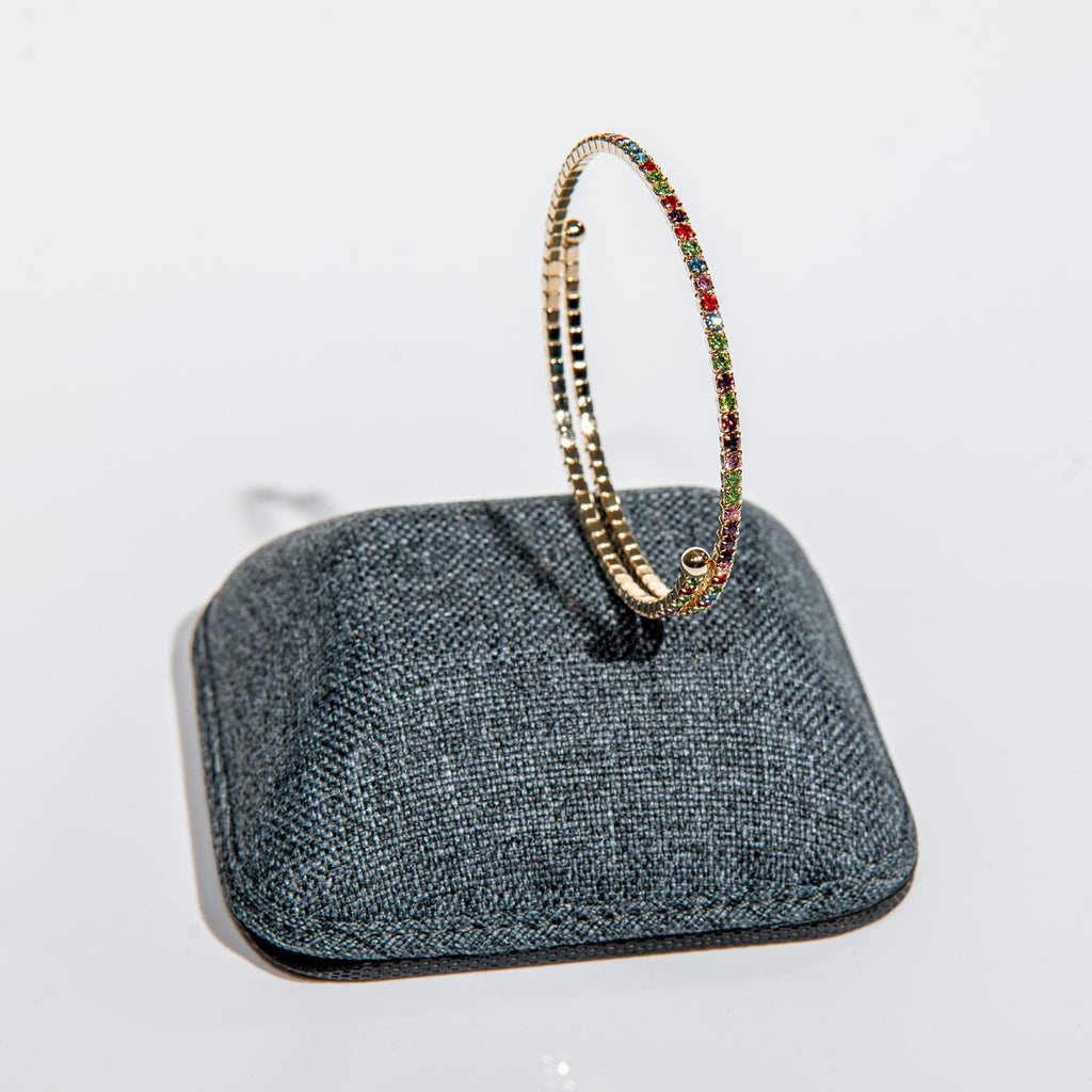 Perfect gift - rainbow crystal bangle in gold featuring slide-on flexible wire design