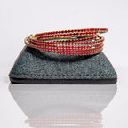 July ruby birthstone bangles in gold with red crystals stacked to demonstrate flexible construction