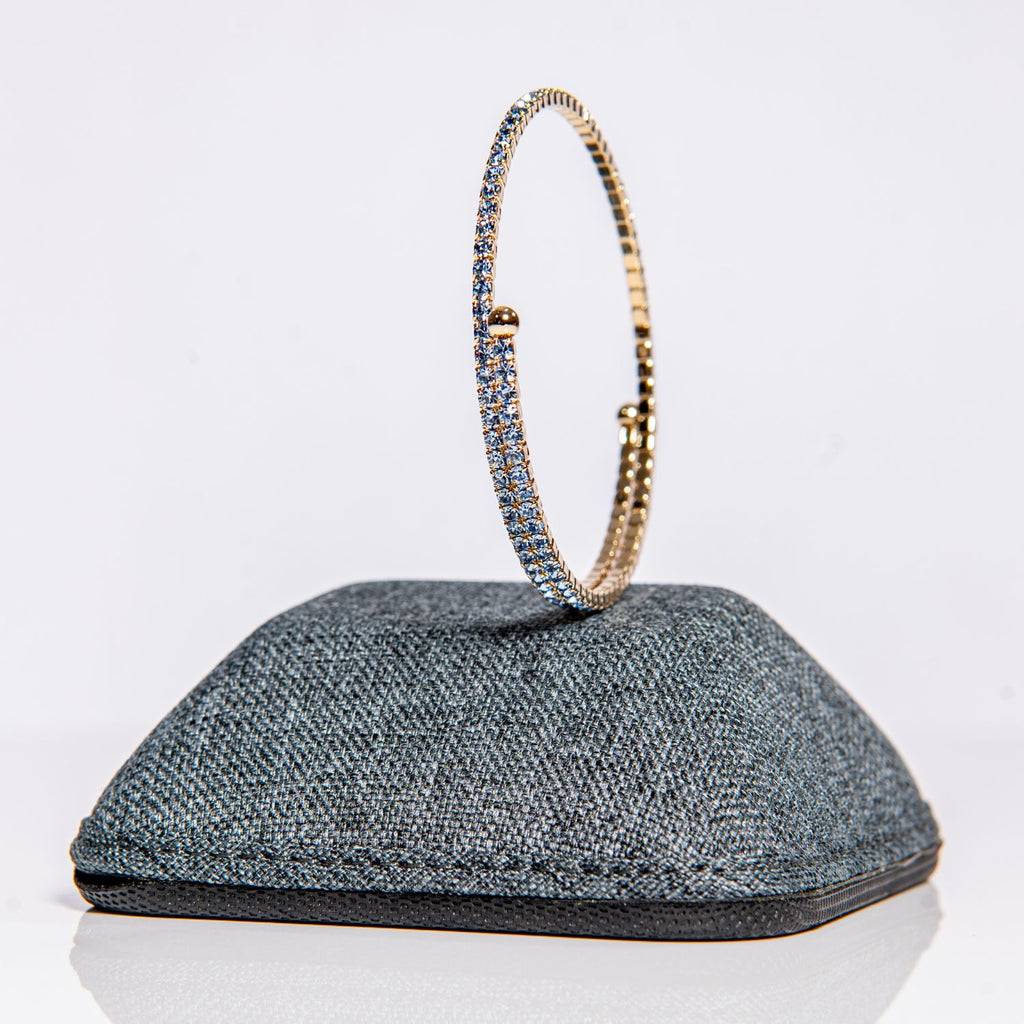 March aquamarine birthstone bangle in gold showing sea-blue crystals on one-size-fits-most design