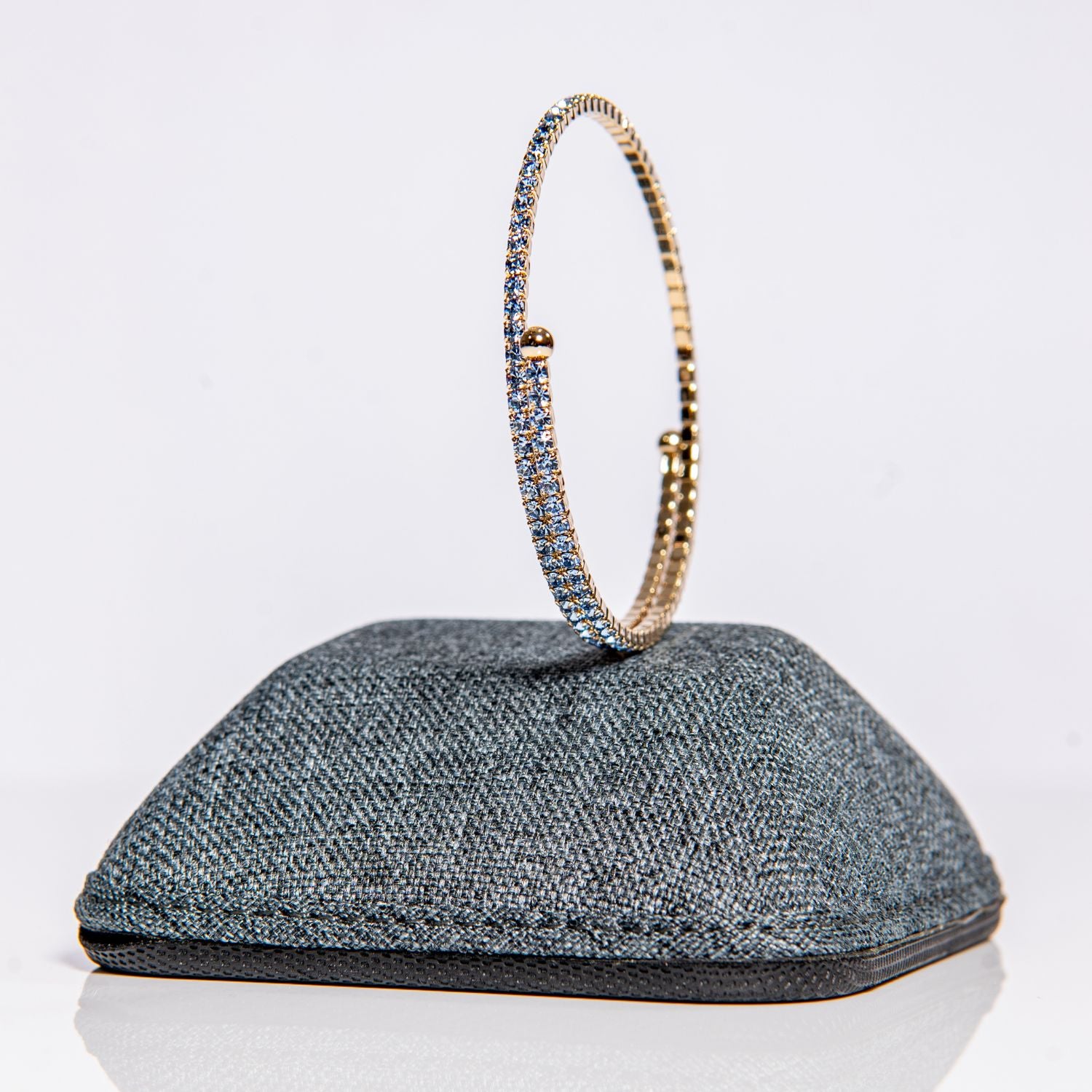 March aquamarine birthstone bangle in gold showing sea-blue crystals on one-size-fits-most design