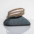 November topaz birthstone bangles in silver with warm golden crystals stacked showing flexible construction