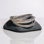 October opal birthstone bangles in silver with rainbow crystals stacked showing one-size-fits-most design