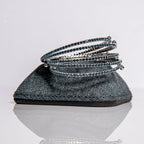 September sapphire birthstone bangles in silver with royal blue crystals stacked showing flexible design